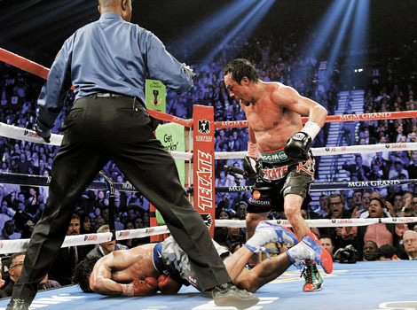 Juan Manuel Marquez of Mexico steps away after knocking out Manny Pacquiao of the Philippines in the 6th round during their welterweight fight at the MGM Grand Garden Arena in Las Vegas